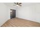 Bright bedroom features neutral walls, ceiling fan, wood-look floors and sliding glass doors at 5220 Landings Blvd # 104, Sarasota, FL 34231