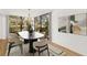 Elegant dining room featuring a modern table, stylish chairs, and scenic views of the outdoors at 5220 Landings Blvd # 104, Sarasota, FL 34231