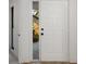 Bright and airy view of the home's entrance, showcasing a white door and tiled flooring at 5220 Landings Blvd # 104, Sarasota, FL 34231