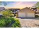 Inviting exterior view showcasing the home's two-car garage and landscaped front yard with a brick paved driveway at 5220 Landings Blvd # 104, Sarasota, FL 34231