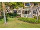 Private patio with lush shrubbery and tropical plants at 5220 Landings Blvd # 104, Sarasota, FL 34231