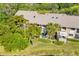 Townhome with a private balcony and a patio, surrounded by lush tropical landscaping at 5220 Landings Blvd # 104, Sarasota, FL 34231