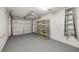 Spacious garage features epoxy floors, storage shelves, and secure garage door at 5220 Landings Blvd # 104, Sarasota, FL 34231