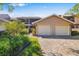 Beautiful home featuring a two-car garage, lush landscaping, and a brick-paved driveway at 5220 Landings Blvd # 104, Sarasota, FL 34231