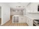 Kitchen with island, stainless steel appliances, and open access to the living space at 5220 Landings Blvd # 104, Sarasota, FL 34231