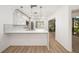 Modern kitchen showcasing sleek white cabinetry, stainless steel appliances, quartz countertops and hardwood floors at 5220 Landings Blvd # 104, Sarasota, FL 34231