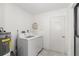 Functional laundry room featuring modern washer and dryer and access to water heater at 5220 Landings Blvd # 104, Sarasota, FL 34231