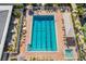 Aerial view of pool with clear blue water, lounge chairs, and a spa for relaxation at 5220 Landings Blvd # 104, Sarasota, FL 34231