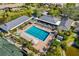 Overhead view of pool and patio with mature trees and landscaping at 5220 Landings Blvd # 104, Sarasota, FL 34231