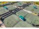 Aerial view of tennis courts with a shaded viewing area at 5220 Landings Blvd # 104, Sarasota, FL 34231