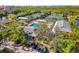 Scenic aerial view of tennis courts and pool with a shaded viewing area at 5220 Landings Blvd # 104, Sarasota, FL 34231