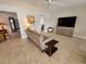 Bright and airy living room with tiled floors and large TV at 529 Belvedere Ct, Punta Gorda, FL 33950