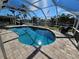 Relaxing kidney-shaped pool with a screened enclosure and canal view at 529 Belvedere Ct, Punta Gorda, FL 33950