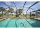 Relaxing pool area with a screened enclosure and backyard views at 543 Spring Lake Nw Blvd, Port Charlotte, FL 33952