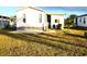 Rear home view with grassy yard and palm tree at 6501 Center Ln, North Port, FL 34287