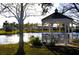 White gazebo overlooking a lake in a park-like setting at 6501 Center Ln, North Port, FL 34287