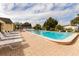 Community pool with lounge chairs and brick-paved deck at 6501 Center Ln, North Port, FL 34287