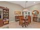 Formal dining room with wood table, chandelier lighting, and elegant decor at 805 Via Formia, Punta Gorda, FL 33950