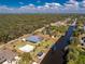 The waterfront home features a boat dock, screened pool, a shed, and a well-maintained lawn, perfect for relaxing at 1052 Eppinger Dr, Port Charlotte, FL 33953