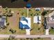 Aerial view of property showcasing the backyard with a screened-in pool and boat dock on canal at 1052 Eppinger Dr, Port Charlotte, FL 33953