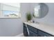 Well-lit bathroom with modern vanity, decor, mirror and a window offering pleasant views at 1052 Eppinger Dr, Port Charlotte, FL 33953