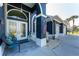 Inviting entryway features double glass doors, decorative fountain and chair with blue cushions at 1052 Eppinger Dr, Port Charlotte, FL 33953