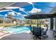 Sparkling pool with a screened enclosure and outdoor dining set at 1052 Eppinger Dr, Port Charlotte, FL 33953