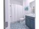Clean bathroom with a shower/tub combo, geometric tile floor, and vanity at 12717 Morning Mist Pl, Venice, FL 34293