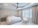 Spacious bedroom with large bed, chair, and window coverings at 12717 Morning Mist Pl, Venice, FL 34293