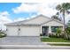 Two-story home with a three-car garage and attractive landscaping at 12717 Morning Mist Pl, Venice, FL 34293