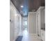 Bright hallway with tile flooring, recessed lighting, and access to multiple rooms at 12717 Morning Mist Pl, Venice, FL 34293