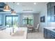 Modern kitchen with white countertops and dark blue cabinets at 12717 Morning Mist Pl, Venice, FL 34293