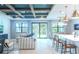 Open living space with high ceilings, modern decor, and sliding glass doors leading to backyard at 12717 Morning Mist Pl, Venice, FL 34293