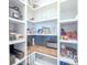 Well-organized pantry with ample shelving and herringbone tile backsplash at 12717 Morning Mist Pl, Venice, FL 34293