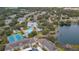 Aerial view of community with pool, tennis courts, and lake at 1407 Red Oak Ln, Port Charlotte, FL 33948