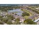 Community aerial view showcasing residences around a tranquil lake, enveloped by lush greenery at 1407 Red Oak Ln, Port Charlotte, FL 33948