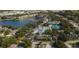 Community aerial view showcasing the pool, tennis courts, lush landscaping, and surrounding neighborhood at 1407 Red Oak Ln, Port Charlotte, FL 33948