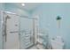 Bright bathroom with a tiled shower and a light blue accent wall at 1407 Red Oak Ln, Port Charlotte, FL 33948