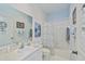 Bathroom with a tub and shower, blue accents, and plenty of counter space at 1407 Red Oak Ln, Port Charlotte, FL 33948