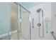 Shower with a white tile surround, grab bars, and a handheld shower head at 1407 Red Oak Ln, Port Charlotte, FL 33948