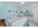 Bright bedroom with a queen-sized bed, light blue walls and a ceiling fan at 1407 Red Oak Ln, Port Charlotte, FL 33948