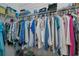 Walk-in closet with shelving and hanging racks and a variety of clothes at 1407 Red Oak Ln, Port Charlotte, FL 33948