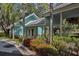 Inviting clubhouse with a covered porch, red flower beds, and serene outdoor space at 1407 Red Oak Ln, Port Charlotte, FL 33948