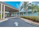 Charming clubhouse featuring a covered entrance, light blue siding, and manicured landscaping at 1407 Red Oak Ln, Port Charlotte, FL 33948