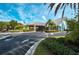 Clubhouse entrance featuring attractive landscaping, a covered entryway, and ample parking at 1407 Red Oak Ln, Port Charlotte, FL 33948