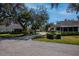 Peaceful neighborhood with manicured lawns, mature trees, and well-maintained homes at 1407 Red Oak Ln, Port Charlotte, FL 33948