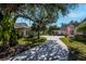 Scenic view of homes within a quiet community, landscaped lawns, and a shared driveway at 1407 Red Oak Ln, Port Charlotte, FL 33948