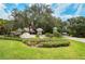 Community entrance with lush landscaping, signage, and well-maintained grounds, creating an inviting experience at 1407 Red Oak Ln, Port Charlotte, FL 33948