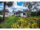 Cute one-story home with a screened porch and lush landscaping at 1407 Red Oak Ln, Port Charlotte, FL 33948