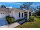 Quaint one-story home with front lawn and a cozy screened-in porch entrance at 1407 Red Oak Ln, Port Charlotte, FL 33948